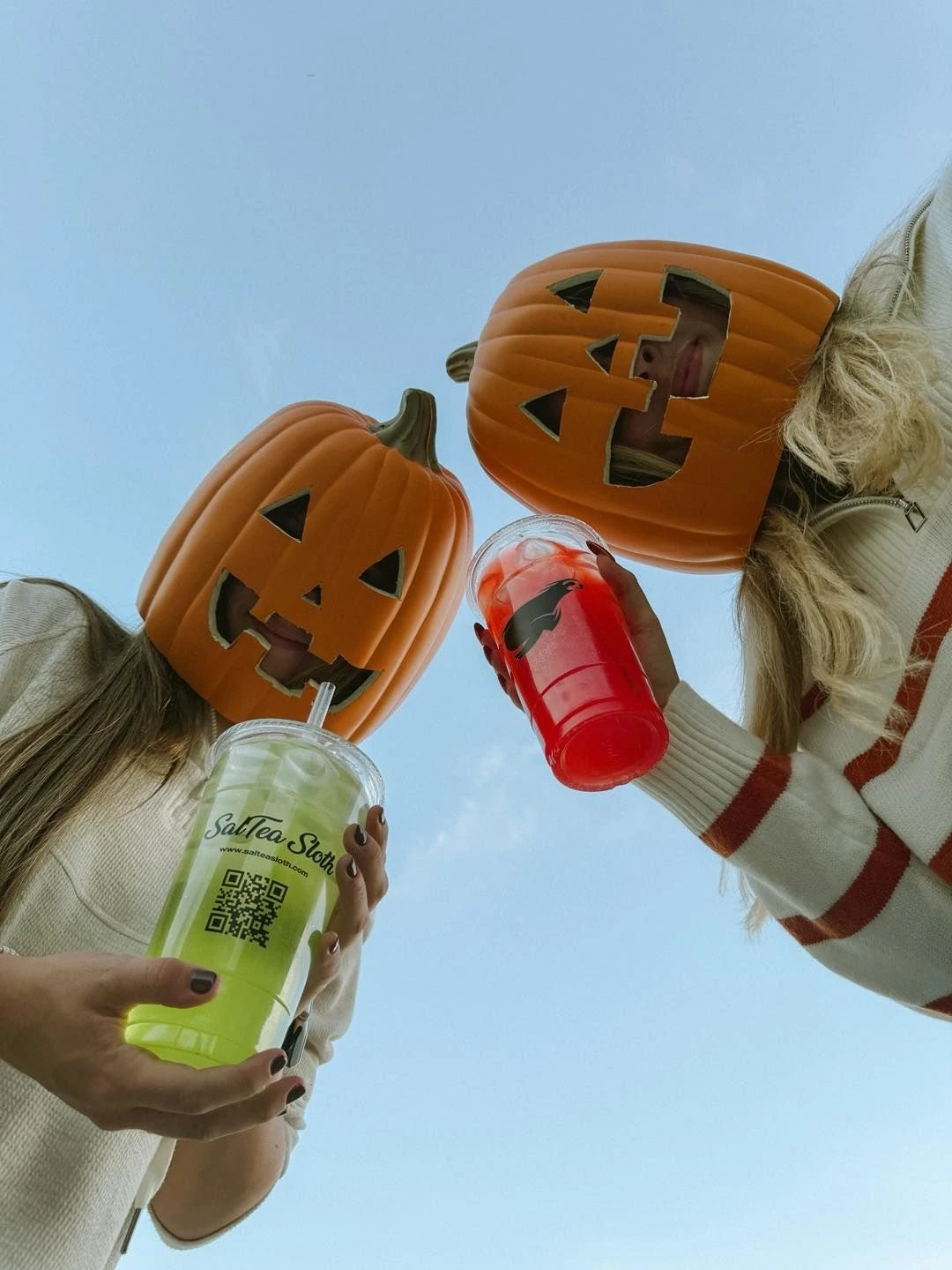 Pumpkin Heads Toasting Drinks Under Sky