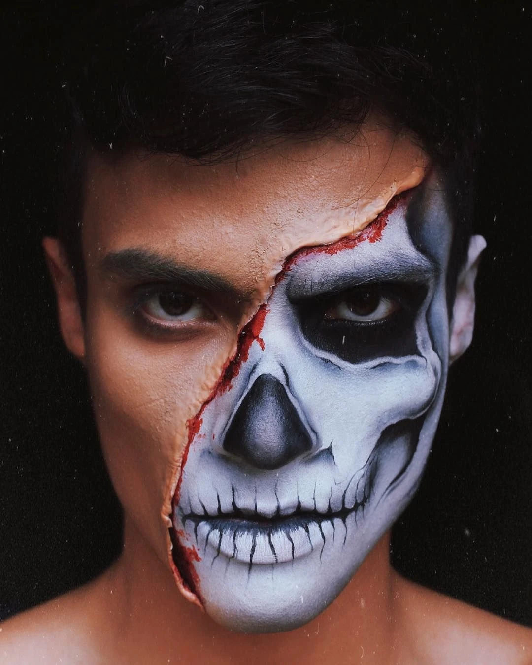Half skull with a red scar