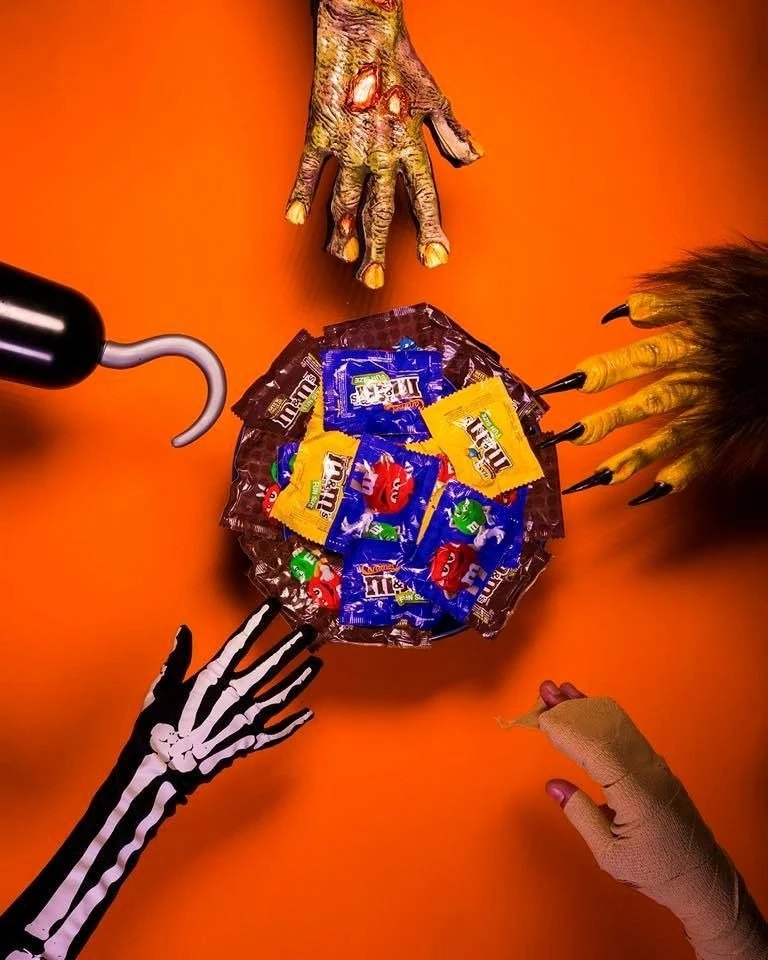 Monster Hands Reaching Into Halloween Candy Bowl