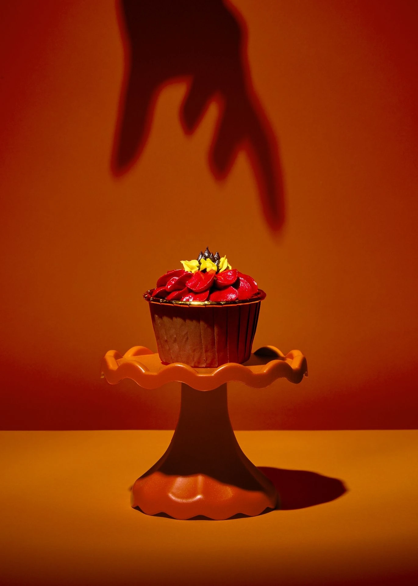 Giant Hand Shadow over Cupcake Stand