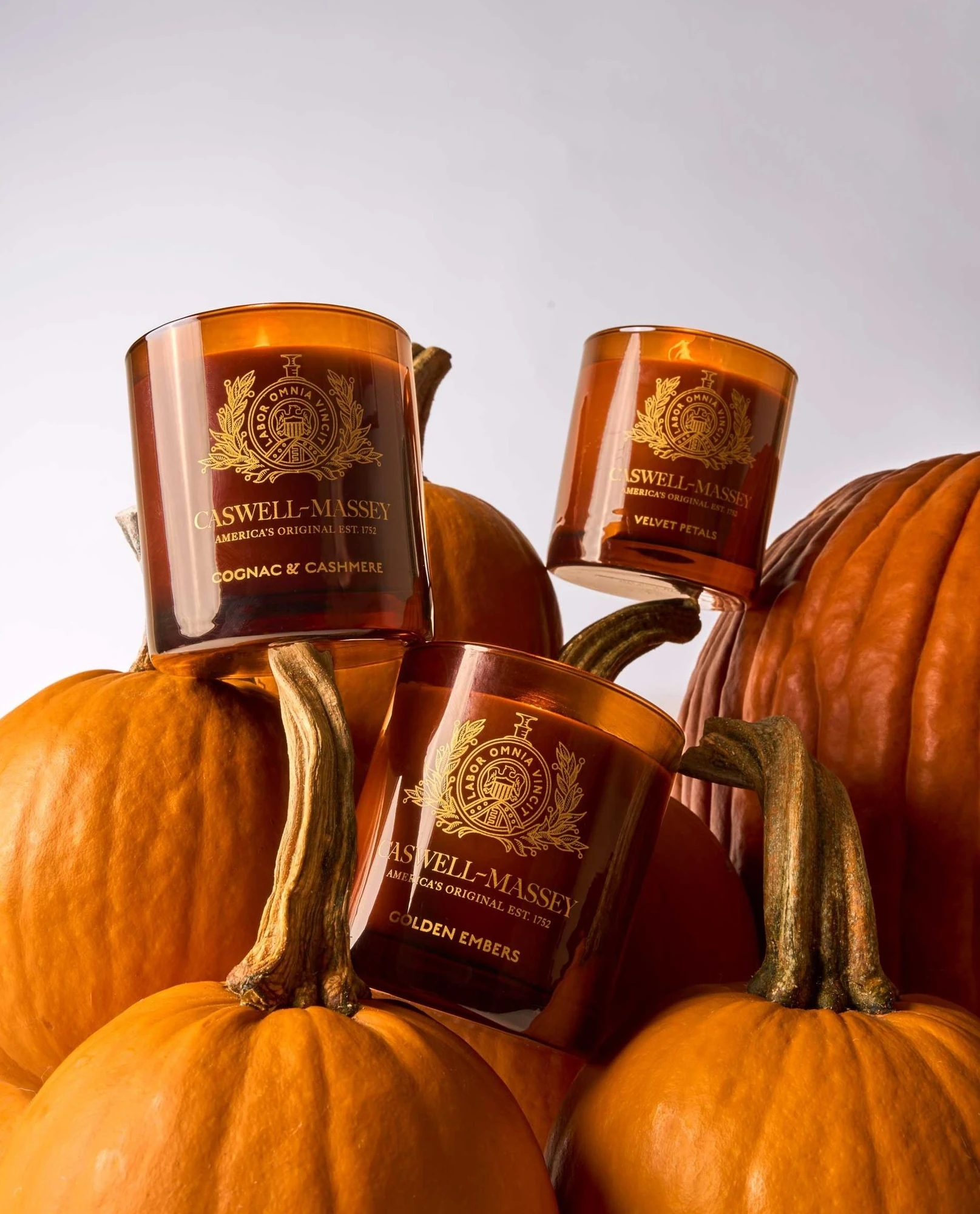 Amber Candle Jars Balanced on Ribbed Pumpkins